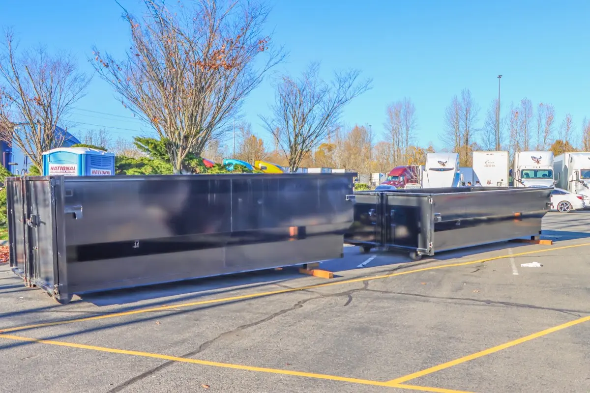 Professional dumpster rental service with roll-off container on residential driveway in Spearfish